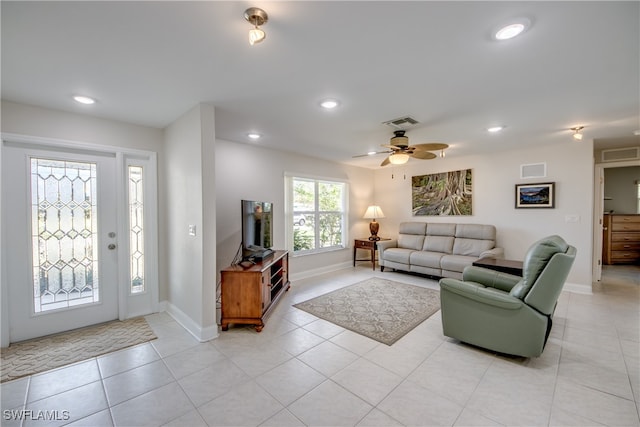 tiled living room featuring ceiling fan