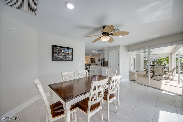 tiled dining space with ceiling fan