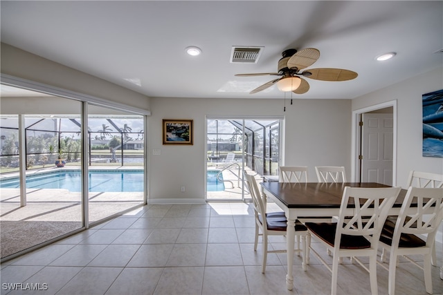 unfurnished dining area featuring ceiling fan, light tile patterned floors, and plenty of natural light