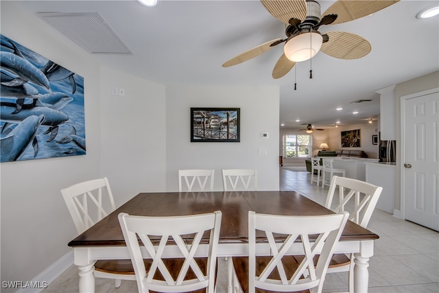 dining room with light tile patterned floors and ceiling fan