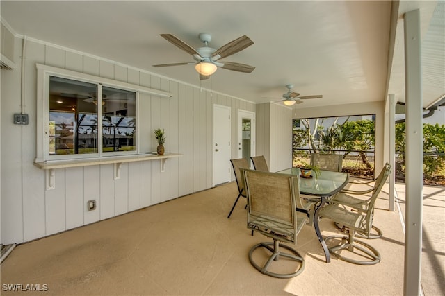 sunroom / solarium featuring ceiling fan