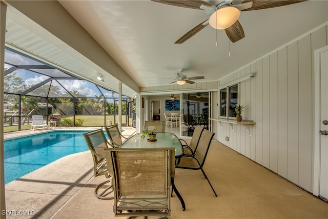 view of swimming pool featuring a patio area, a lanai, and ceiling fan