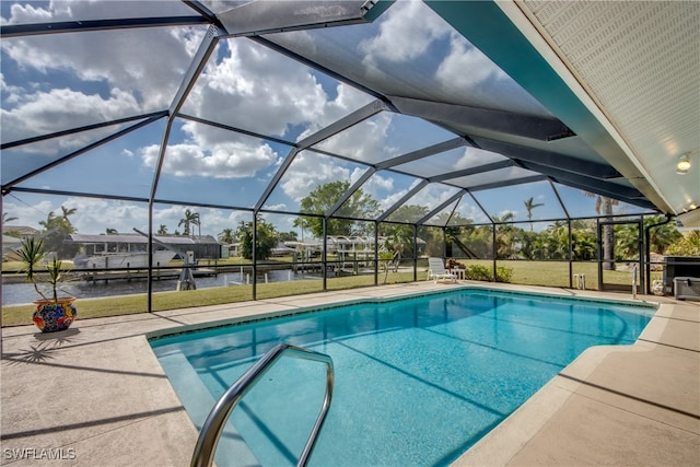 view of swimming pool with a water view, a patio area, glass enclosure, and a yard