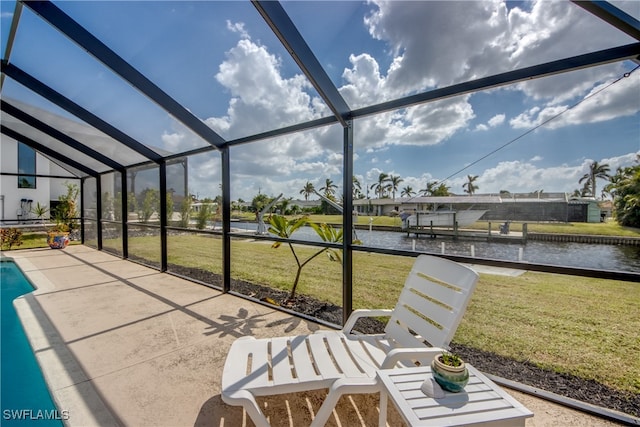 unfurnished sunroom featuring lofted ceiling and a water view