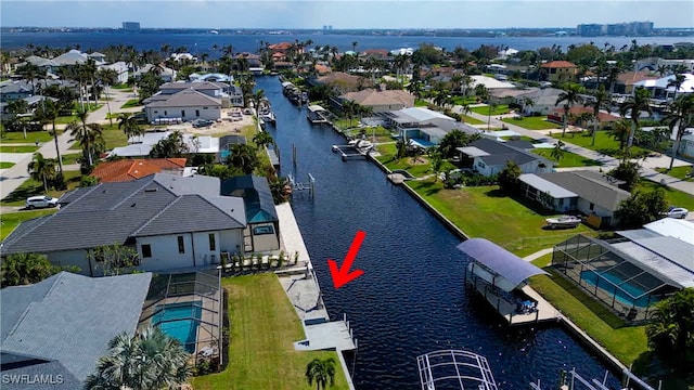 birds eye view of property with a water view