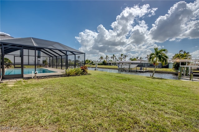 exterior space with a water view, glass enclosure, and a dock