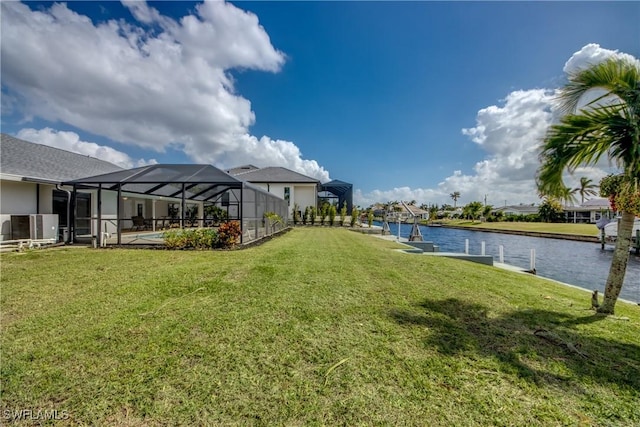 1106 Lorraine Ct, Cape Coral, FL 33904 - view of grassy yard featuring a water view, a boat dock, and glass enclosure