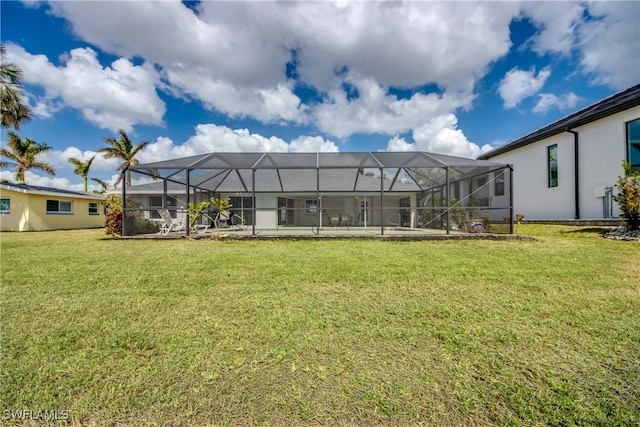 1106 Lorraine Ct, Cape Coral, FL 33904 - back of house with a lawn, glass enclosure, and stucco siding