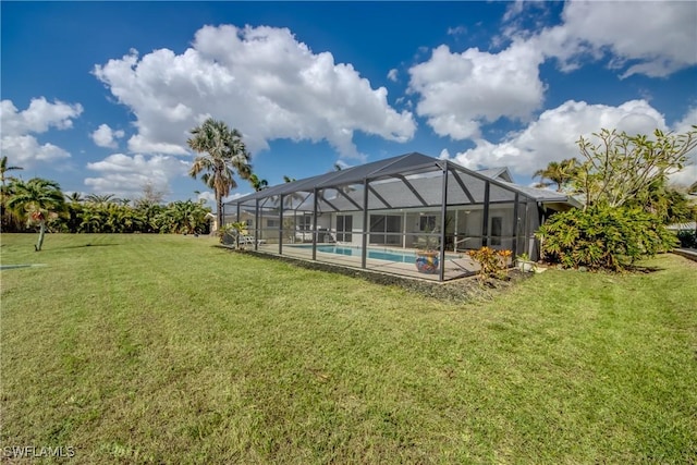 1106 Lorraine Ct, Cape Coral, FL 33904 - view of grassy yard featuring an outdoor pool and a lanai