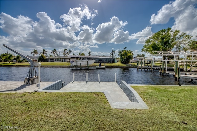 view of dock with a water view and a lawn