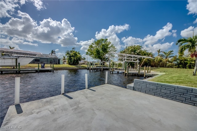 dock area featuring a lawn and a water view