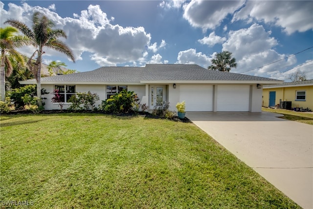 ranch-style home with a garage and a front lawn