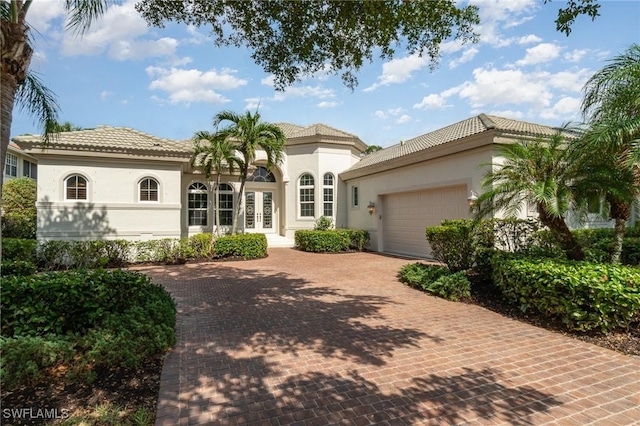 mediterranean / spanish home with a garage