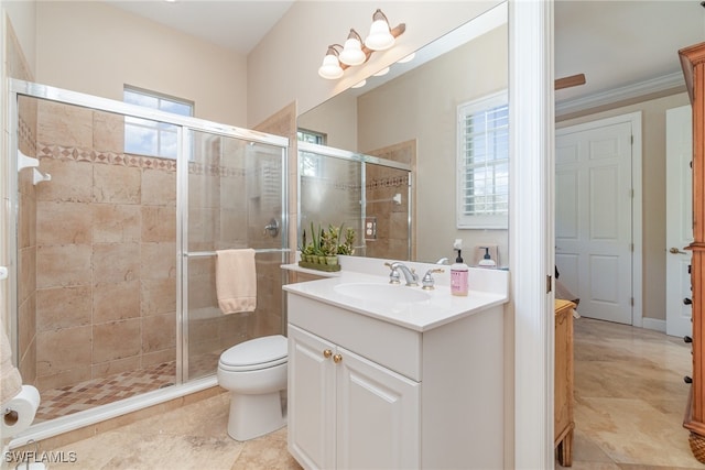 bathroom featuring vanity, tile patterned floors, crown molding, toilet, and walk in shower