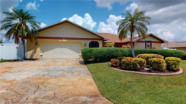 ranch-style house featuring a garage and a front yard