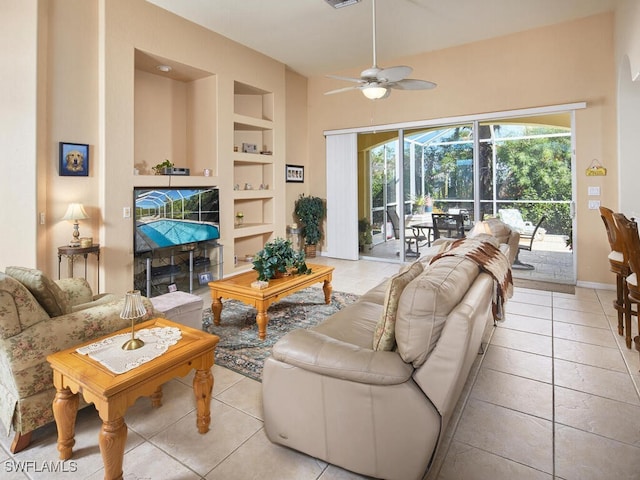 living room with ceiling fan, built in features, and light tile patterned floors