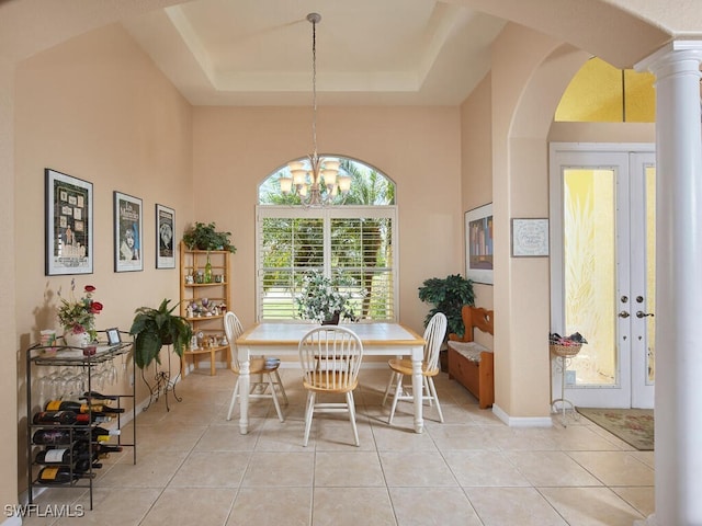 1442 Biscayne Way, Marco Island, FL 34145 - dining area featuring arched walkways, a high ceiling, light tile patterned flooring, and a notable chandelier