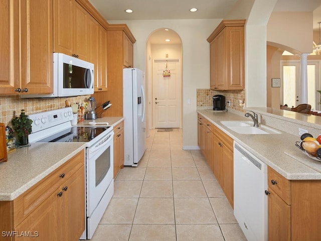 1442 Biscayne Way, Marco Island, FL 34145 - kitchen featuring backsplash, arched walkways, a sink, white appliances, and light tile patterned flooring