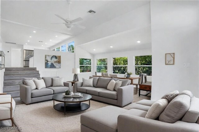 living area featuring visible vents, a ceiling fan, lofted ceiling, stairs, and recessed lighting