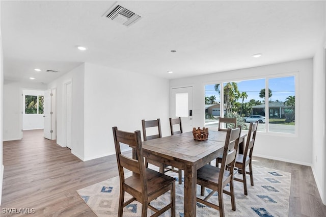 dining area with baseboards, recessed lighting, visible vents, and light wood-style floors