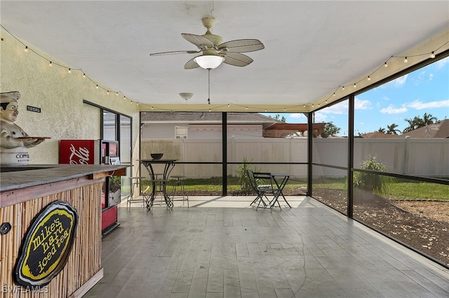 sunroom / solarium featuring ceiling fan