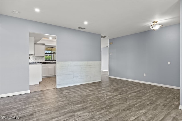 empty room with light hardwood / wood-style flooring