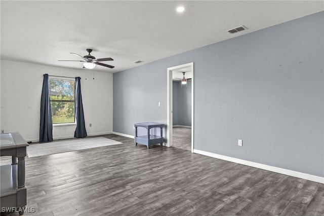 unfurnished room featuring dark wood-type flooring and ceiling fan