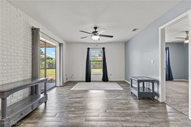 empty room featuring dark wood-type flooring and ceiling fan