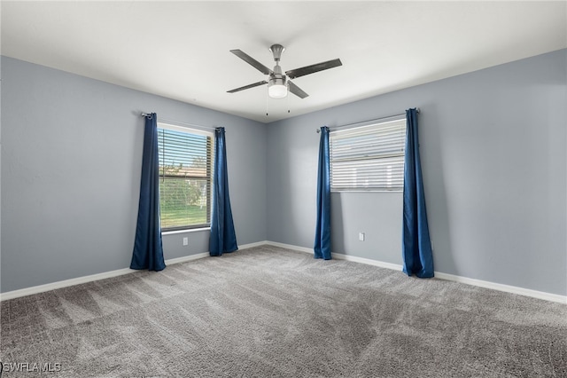 empty room featuring light colored carpet and ceiling fan