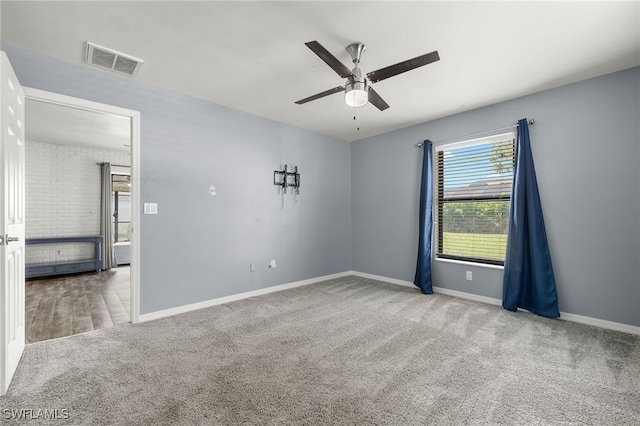 carpeted spare room featuring ceiling fan