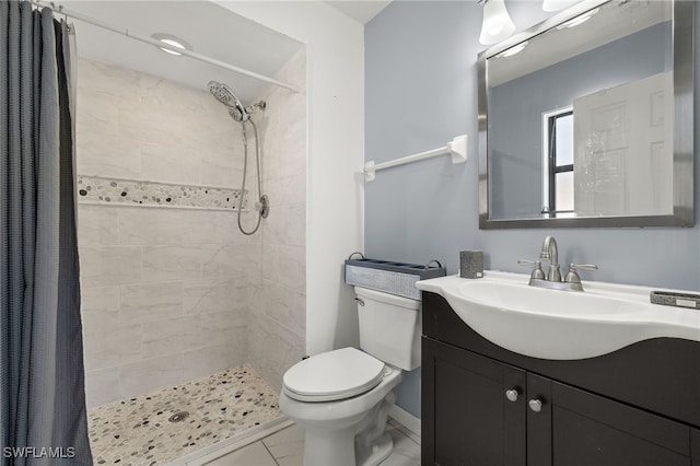 bathroom featuring a shower with shower curtain, tile patterned flooring, vanity, and toilet