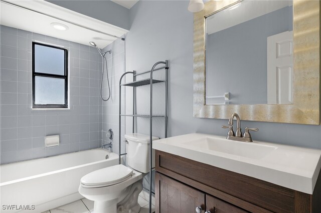 full bathroom with vanity, tile patterned floors, tiled shower / bath, and toilet