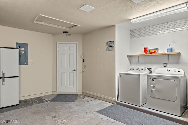 clothes washing area with electric panel, independent washer and dryer, and a textured ceiling