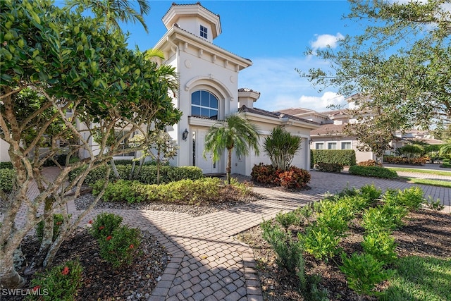 mediterranean / spanish-style house with a garage