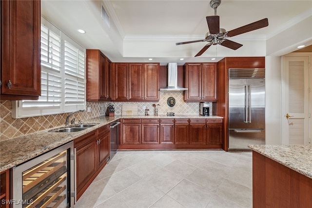 kitchen with crown molding, stainless steel appliances, light stone countertops, beverage cooler, and wall chimney exhaust hood