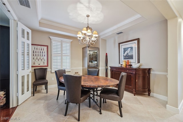 dining room with ornamental molding, a chandelier, a raised ceiling, and light tile patterned flooring