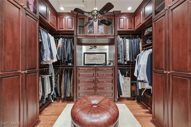 walk in closet with light hardwood / wood-style floors and ceiling fan