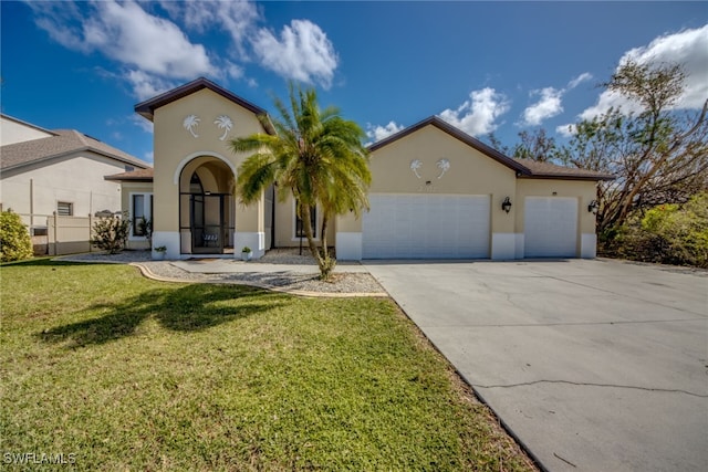 mediterranean / spanish home with a front yard and a garage