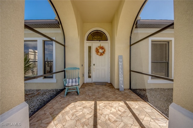 property entrance featuring a patio