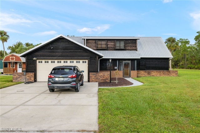 view of front of property with a garage and a front lawn