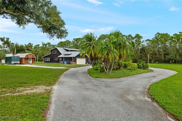 view of front of property featuring a garage and a front lawn