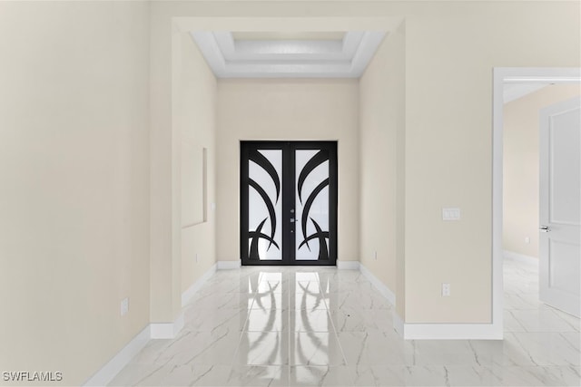 entryway featuring a tray ceiling