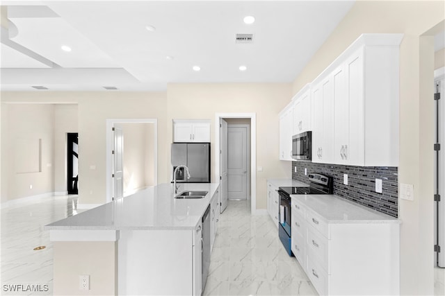 kitchen featuring white cabinetry, sink, tasteful backsplash, a center island with sink, and appliances with stainless steel finishes