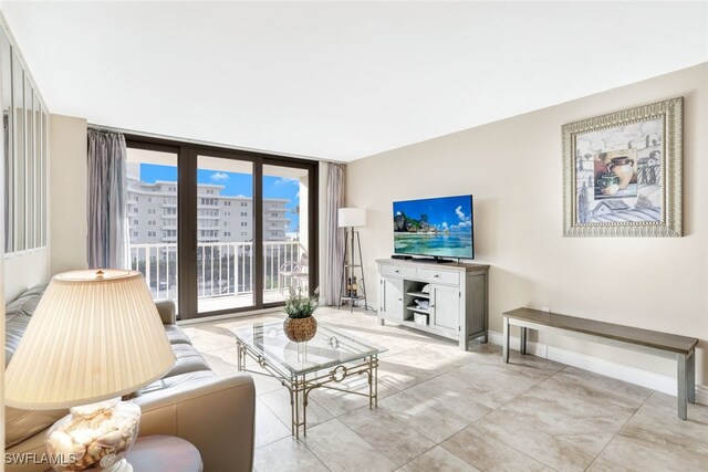 living room with a wall of windows and baseboards