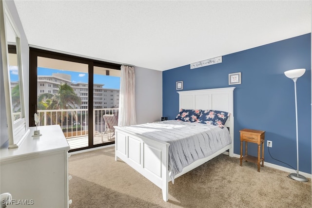 bedroom featuring access to outside, baseboards, and light carpet