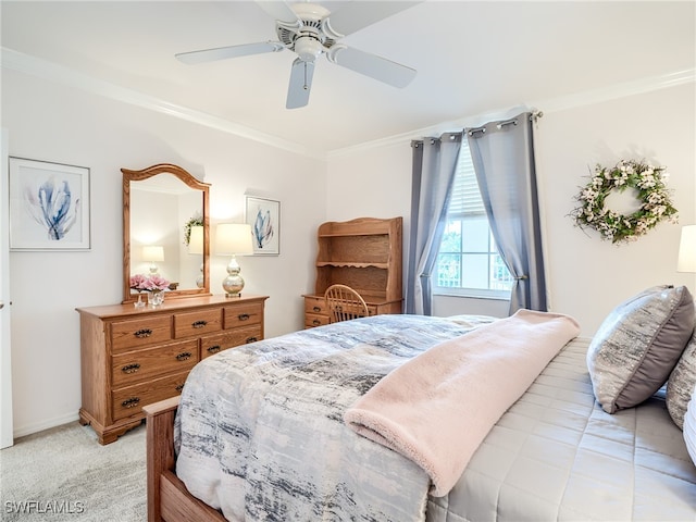 carpeted bedroom with ceiling fan and crown molding