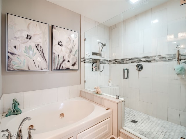 bathroom featuring shower with separate bathtub