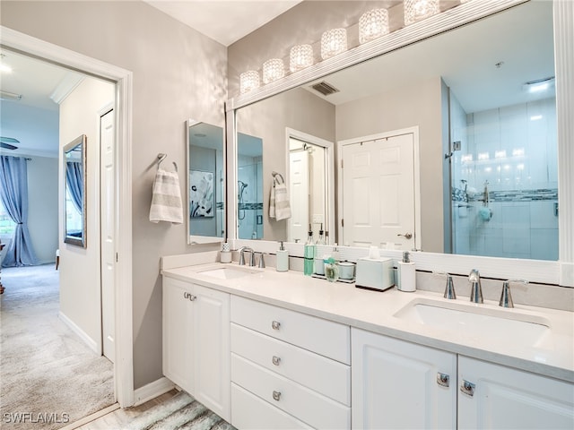 bathroom featuring vanity and an enclosed shower