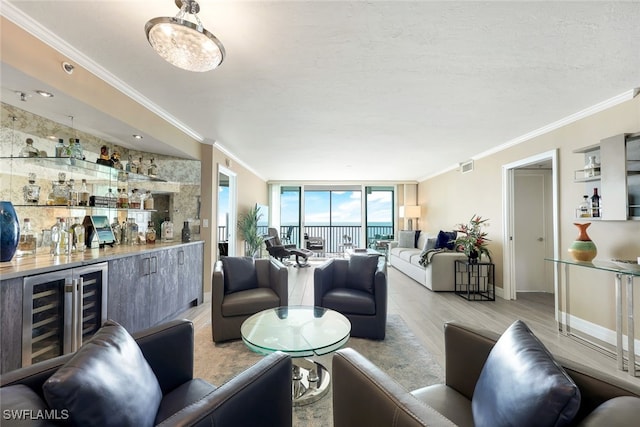 living room with floor to ceiling windows, beverage cooler, light wood-type flooring, indoor bar, and ornamental molding