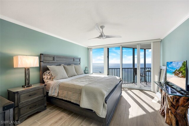 bedroom with ceiling fan, floor to ceiling windows, access to outside, and multiple windows